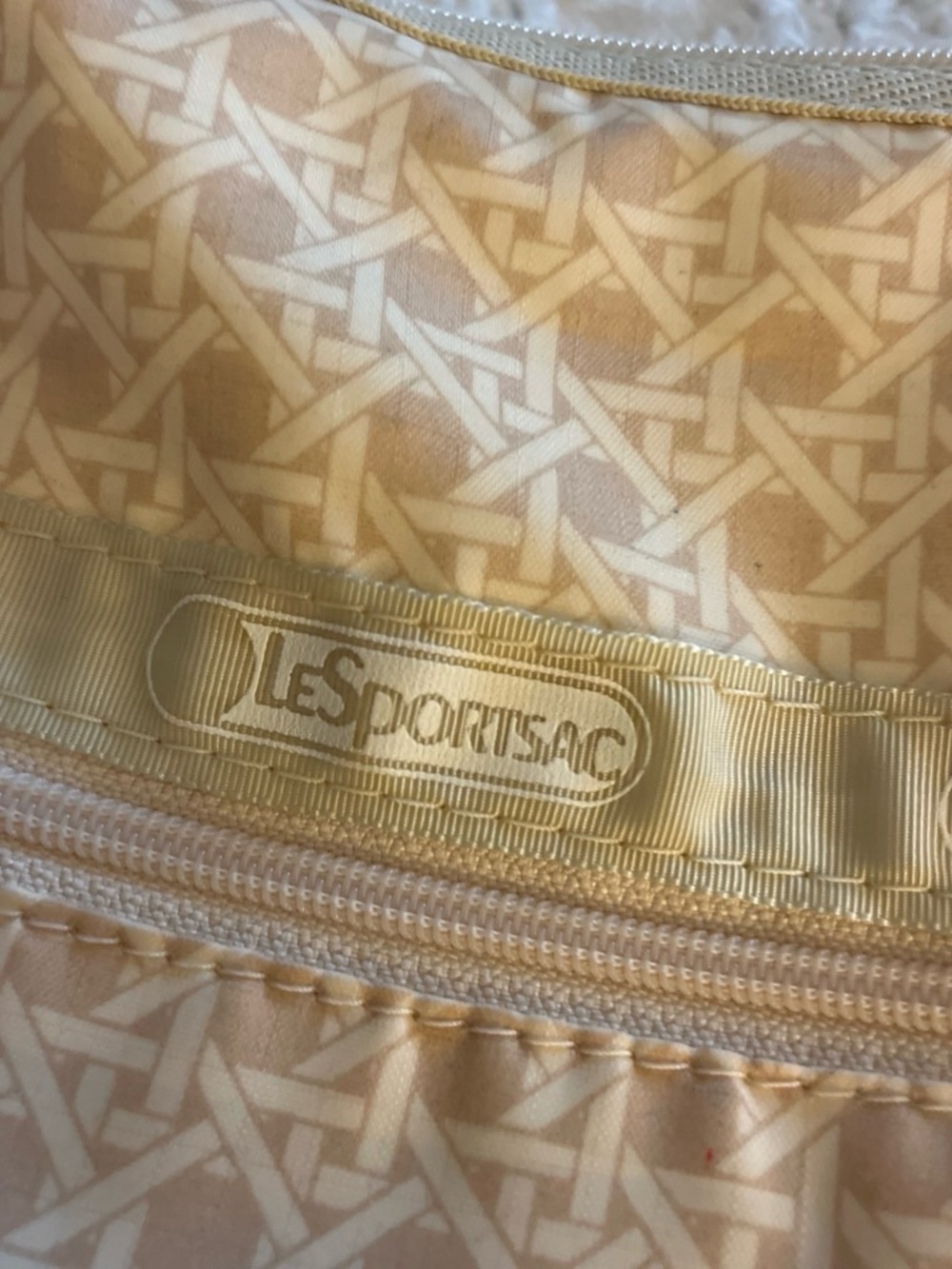 LeSportsac cream and beige patterned pouch